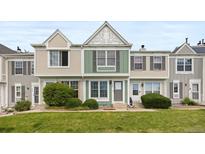 Inviting townhome with manicured lawn and charming architectural details, perfect for comfortable living at 10886 Bayfield Way, Parker, CO 80138
