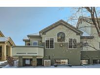 Two-story townhouse showcasing unique architectural design and complemented by a snow-covered landscape, offering a modern and cozy appeal at 4143 Da Vinci Dr, Longmont, CO 80503