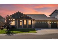 Charming single-Gathering home boasting a manicured lawn and a two-car garage against a backdrop of a beautiful sunset at 3853 S Malta St, Aurora, CO 80013