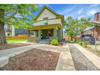 Charming two-story home with a covered front porch and well-maintained landscaping at 2143 S Acoma St, Denver, CO 80223