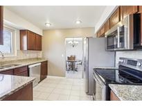 Updated kitchen features stainless steel appliances and granite countertops at 12097 E Mexico Ave, Aurora, CO 80012