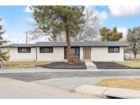 Inviting single-story home with a new roof, fresh exterior paint, and attractive landscaping showcasing its curb appeal at 2505 Upham St, Lakewood, CO 80214
