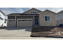 Charming home with a two-car garage and a stone facade at 6966 E 126Th Pl, Thornton, CO 80602