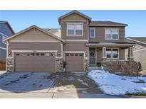 Charming two-story home showcasing a three-car garage and inviting front porch at 7258 Oasis Dr, Castle Rock, CO 80108