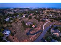 Expansive aerial view of the property with scenic mountain views and neighborhood setting at dusk at 386 Monte Vista Rd, Golden, CO 80401