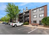 Exterior view of condo building shows balconies and parking with assigned space and easy access to the unit at 6388 Oak Ct # 104, Arvada, CO 80004