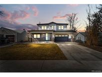 Charming two-story home with a well-manicured lawn and long driveway at 3041 S Bellaire S St, Denver, CO 80222