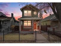 Charming two-story home with a front porch and black iron fence, perfect for enjoying neighborhood views at 3932 Tejon St, Denver, CO 80211