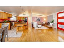 Bright, open-concept living space featuring a modern kitchen and inviting seating area at 2370 S Meade St, Denver, CO 80219