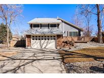 Charming two-story home featuring a two-car garage, brick accents and a cozy front porch at 642 Deframe Ct, Golden, CO 80401