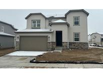 Charming two-story home featuring a covered entrance, attached garage, and well-maintained landscaping at 16890 Black Rose Pl, Parker, CO 80134