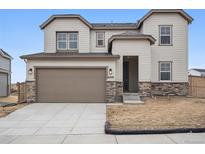 Charming two-story home featuring a two-car garage, stone accents, and neutral-colored siding for a welcoming curb appeal at 16890 Black Rose Pl, Parker, CO 80134