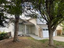 Charming two-story home with light siding, landscaped front yard, and an attached two car garage at 4812 S Bahama Way, Aurora, CO 80015