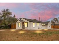 Charming single-story home featuring a cozy front porch, a well-maintained yard, and fresh exterior paint at 2601 W Amherst Ave, Denver, CO 80236
