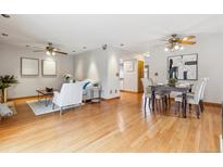Open-concept living and dining area featuring hardwood floors and neutral décor at 138 S Holman Way, Golden, CO 80401