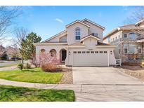 Charming stucco two-story home with a well-manicured lawn and a two-car garage in a suburban neighborhood at 24784 E Arkansas Pl, Aurora, CO 80018