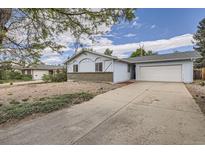Charming single-Gathering home featuring a two-car garage and a well-maintained front yard at 12879 E Oregon Dr, Aurora, CO 80012