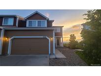 Lovely home with two-car garage, gravel landscaping and a scenic sunset view at 1653 Valley Oak Ct, Castle Rock, CO 80104