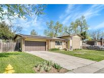Charming single-Gathering home with brick accents, mature trees, and a well-manicured lawn at 6018 Owens St, Arvada, CO 80004