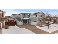 Two-story house with attached garage and snowy front yard at 20602 E Jefferson Ave, Aurora, CO 80013