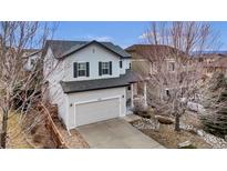 Charming two-story home with a well-manicured lawn, inviting curb appeal, and attached two car garage at 3129 Open Sky Way, Castle Rock, CO 80109