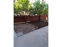 Backyard area features a garden area with wood fence and concrete patio at 10115 W 25Th Ave # 1, Lakewood, CO 80215