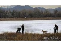 Scenic view of community walking path by water and mountains at 10115 W 25Th Ave # 1, Lakewood, CO 80215