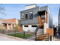 Modern two-story home with gray siding and a landscaped front yard at 3444 Mariposa St, Denver, CO 80211