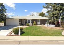 Charming single-story brick home featuring a well-maintained lawn and a welcoming front porch at 2301 Dunbar Ct, Longmont, CO 80501