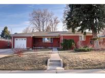 Charming brick home featuring a well-maintained front yard and an attached garage at 5460 E Bails Dr, Denver, CO 80222