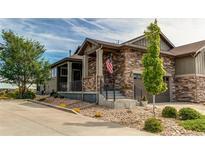 Beautiful exterior of a stone-accented home with landscaped yard and charming front porch at 3367 New Haven Cir, Castle Rock, CO 80109