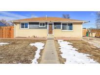 Charming single-story home featuring a brick facade, new paint, and a well-maintained lawn at 1281 Myrtle St, Brighton, CO 80601