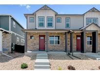 Charming townhome featuring stone accents, covered porch, and well-maintained landscaping at 22322 E 7Th Pl, Aurora, CO 80018