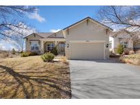 Charming single Gathering home with stone accents, manicured lawn, and a two-car garage at 4932 Democrat Dr, Broomfield, CO 80023