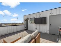 View of a comfortable outdoor patio with lounge furniture and string lights, ideal for relaxing or entertaining at 1232 N Yates St # 3, Denver, CO 80204