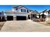 Charming two-story home with a two-car garage and well-maintained landscaping at 9695 Nucla St, Commerce City, CO 80022