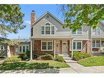 Charming multi-level townhouse featuring a brick and siding facade with well-manicured landscaping at 18171 E Arizona Ave # B, Aurora, CO 80017