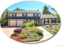 Two-story house with a landscaped yard and attached two-car garage at 1866 W Davies Ave, Littleton, CO 80120