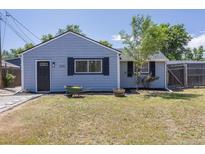 Charming light-blue home with tidy front yard, black shutters and a wheelbarrow at 3570 Center Ave, Denver, CO 80219