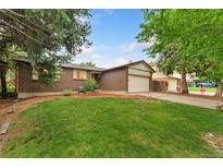 Charming brick home featuring a well-maintained front lawn and an attached two-car garage at 15104 E Utah Pl, Aurora, CO 80012