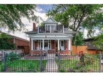Charming two-story home featuring a red brick facade, front porch, and balcony at 3779 Quitman St, Denver, CO 80212