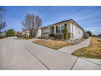 Charming single-story home featuring a well-maintained front yard and attached two-car garage at 1481 Red Poppy Way, Brighton, CO 80601