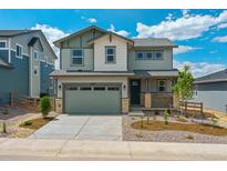 Charming two-story home boasts a well-manicured front yard, stone accents, and a welcoming front porch at 8295 Snake River St, Littleton, CO 80125