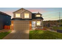 Charming two-story home featuring a brick-accented garage and inviting front porch at 21851 Omaha Ave, Parker, CO 80138