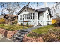 Charming brick home features a landscaped front yard and a welcoming walkway at 1282 S Sherman St, Denver, CO 80210