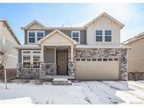 Charming two-story home with a stone facade and attached two car garage at 16278 E 111Th Pl, Commerce City, CO 80022