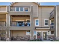 Charming condo building with multiple levels and balconies, plus well maintained landscaping with a brick facade at 11250 Florence St # 30B, Commerce City, CO 80640