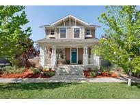 Charming two-story home boasting a welcoming front porch and a beautifully landscaped yard at 2161 Willow Ct, Denver, CO 80238
