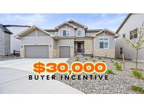 Beautiful two-story home with stone accents, a wide driveway, and a $30,000 buyer incentive at 5411 Edenborn Way, Castle Rock, CO 80104