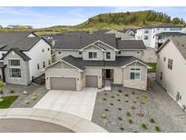 Beautiful two-story home with a three-car garage and stone accents at 5411 Edenborn Way, Castle Rock, CO 80104